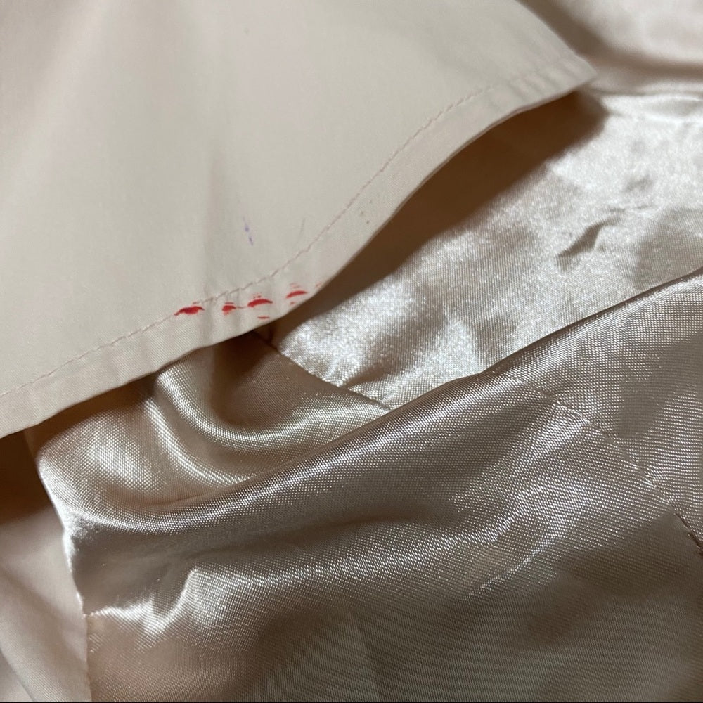 Close-up of red staining on ruffle hem