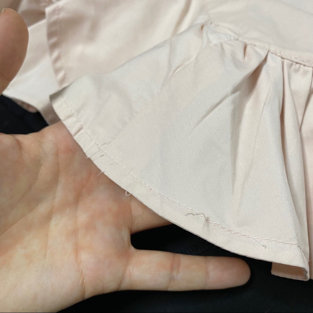 Close-up of ruffle hem and loose threads