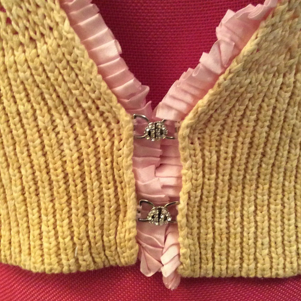 Anthropologie Laurie B sweater rhinestone clasps and pink pleat trim - close-up