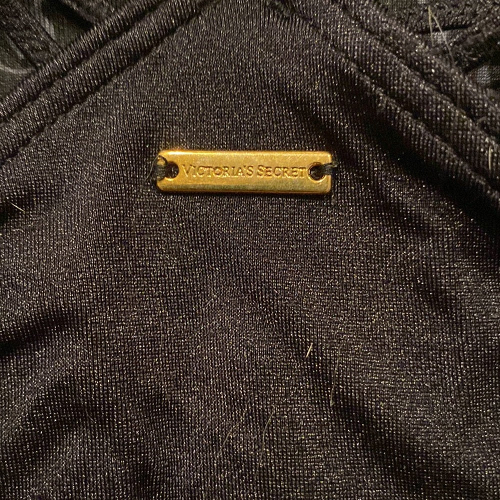 Victoria's Secret black lace bikini bottoms - logo plaque close-up